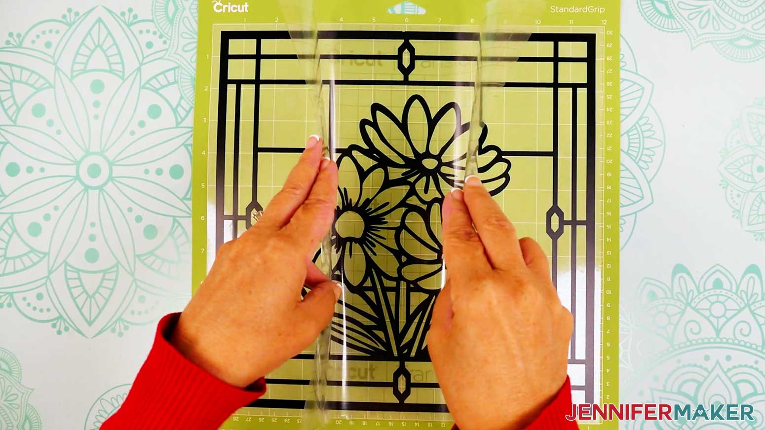 Use the taco method to apply the transfer tape to the top of the vinyl layer of the stained glass design.