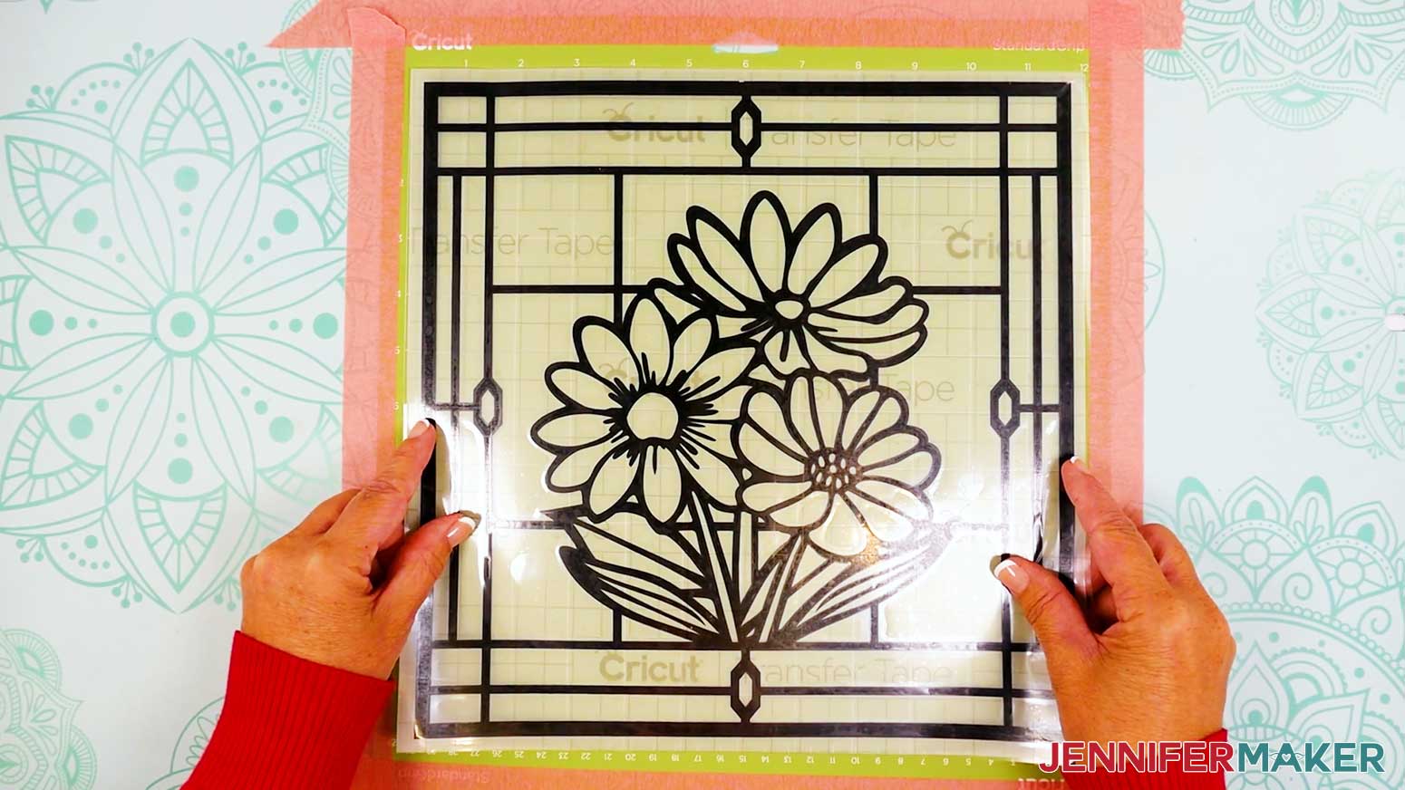 Smooth the transfer tape onto the vinyl layer of the stained glass design.