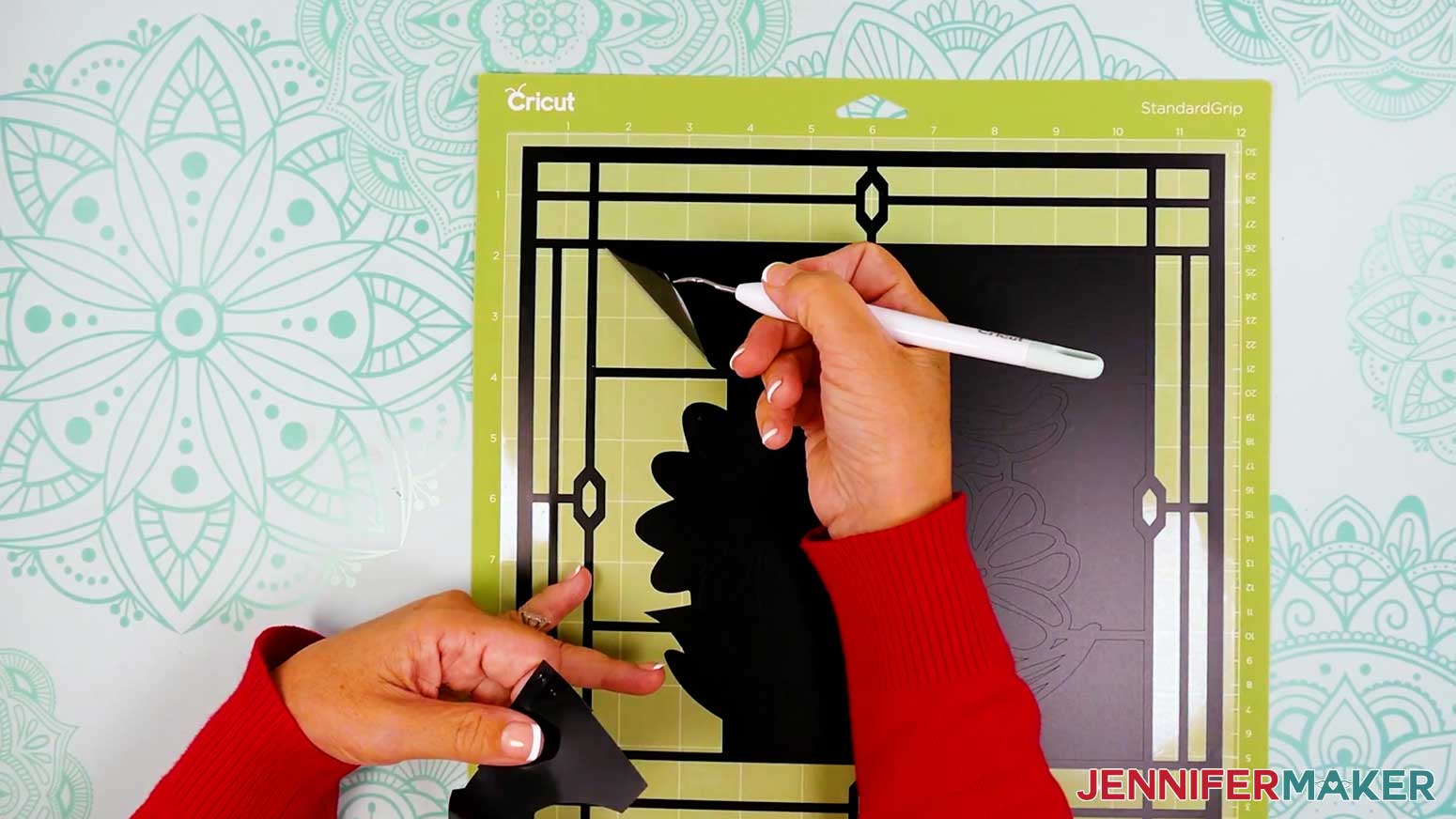 Use the weeding tool to remove the inside areas of the background on the vinyl layer of the stained glass design.