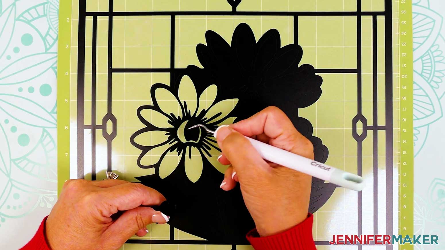 Use a weeding tool to remove intricate areas of the vinyl layer of the stained glass design.