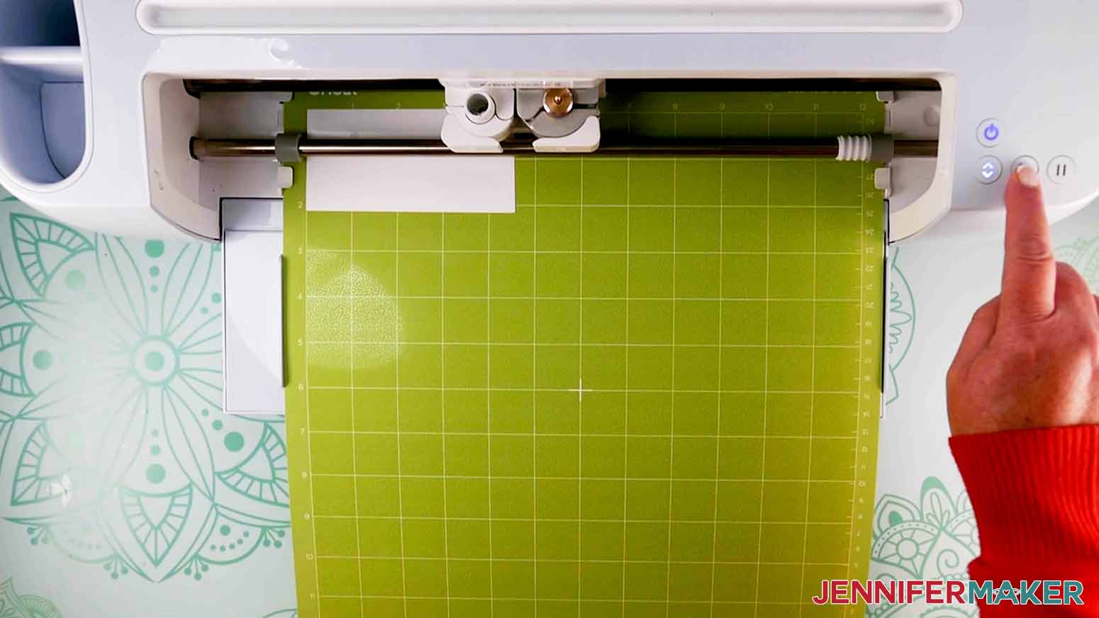 green mat with white vinyl loaded into cricut cutting machine