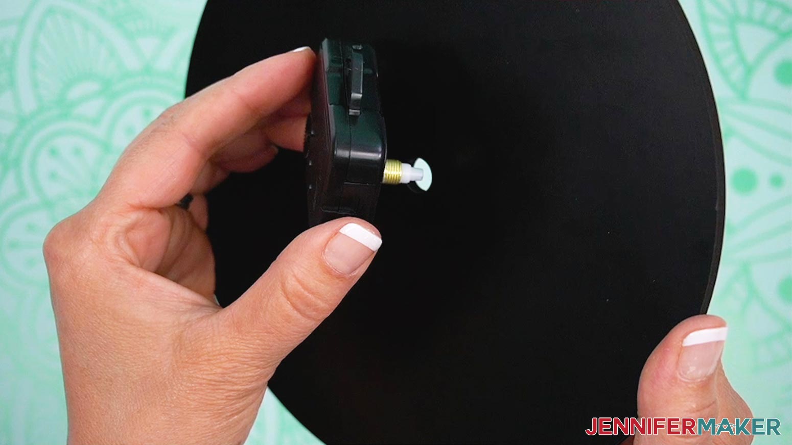 Insert the prong from the clock mechanism through the hole in the center of your clock from the back.