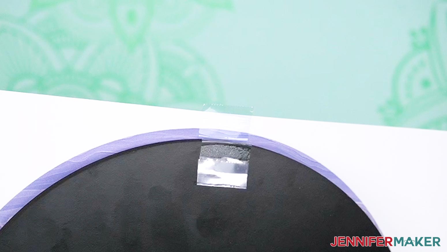 Press the excess tape onto the back of the print.