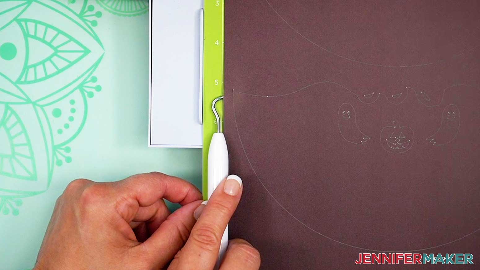 Gently lift the side of the infusible ink to check the cut.
