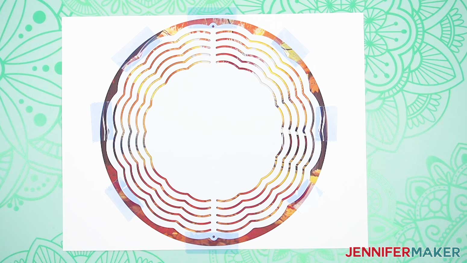 Use heat resistant tape to attach the wind spinner blank to the sublimation print.