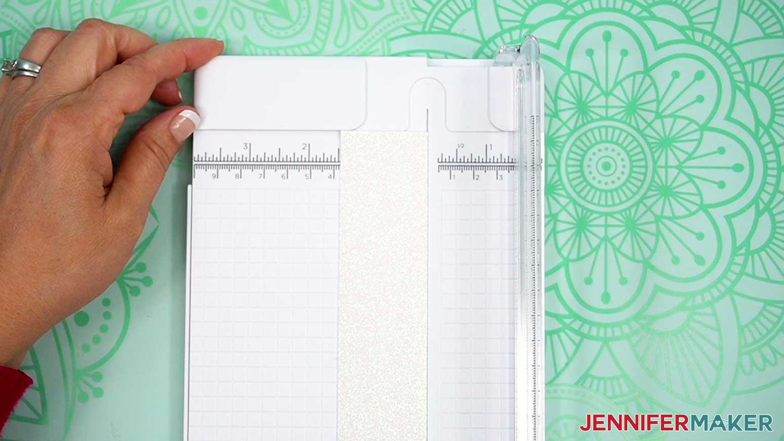 Use a trimmer to cut a piece of faux leather slightly larger than the design.