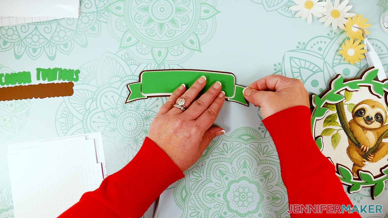 Use foam adhesive to attach the green banner pieces to the white banner piece.