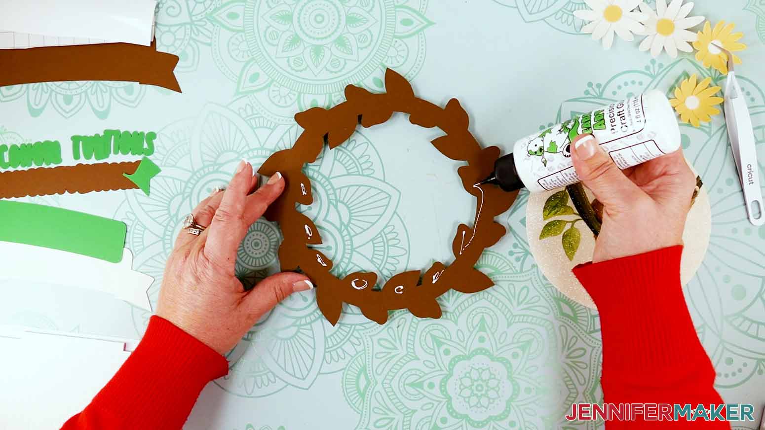 Apply craft glue to the back of the brown wreath layer around the inside circle area of the leaves.
