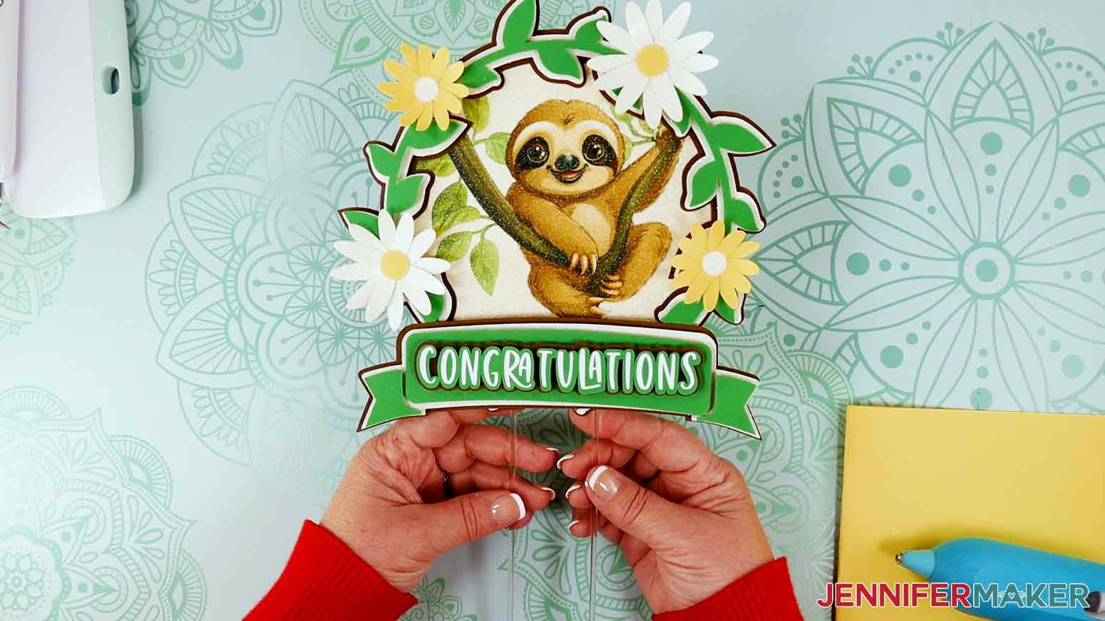 Complete sublimation sloth cake topper with congratulations sentiment.