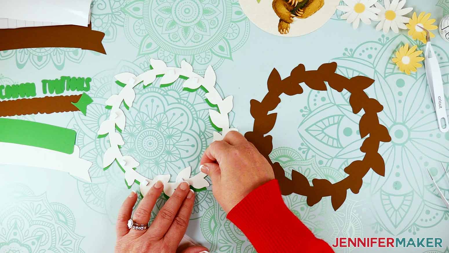 Place foam adhesive on the back side of the white glitter leaf wreath.