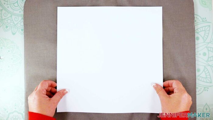 Place a piece of plain white cardstock on a pressing mat to protect the mat from the sublimation ink.