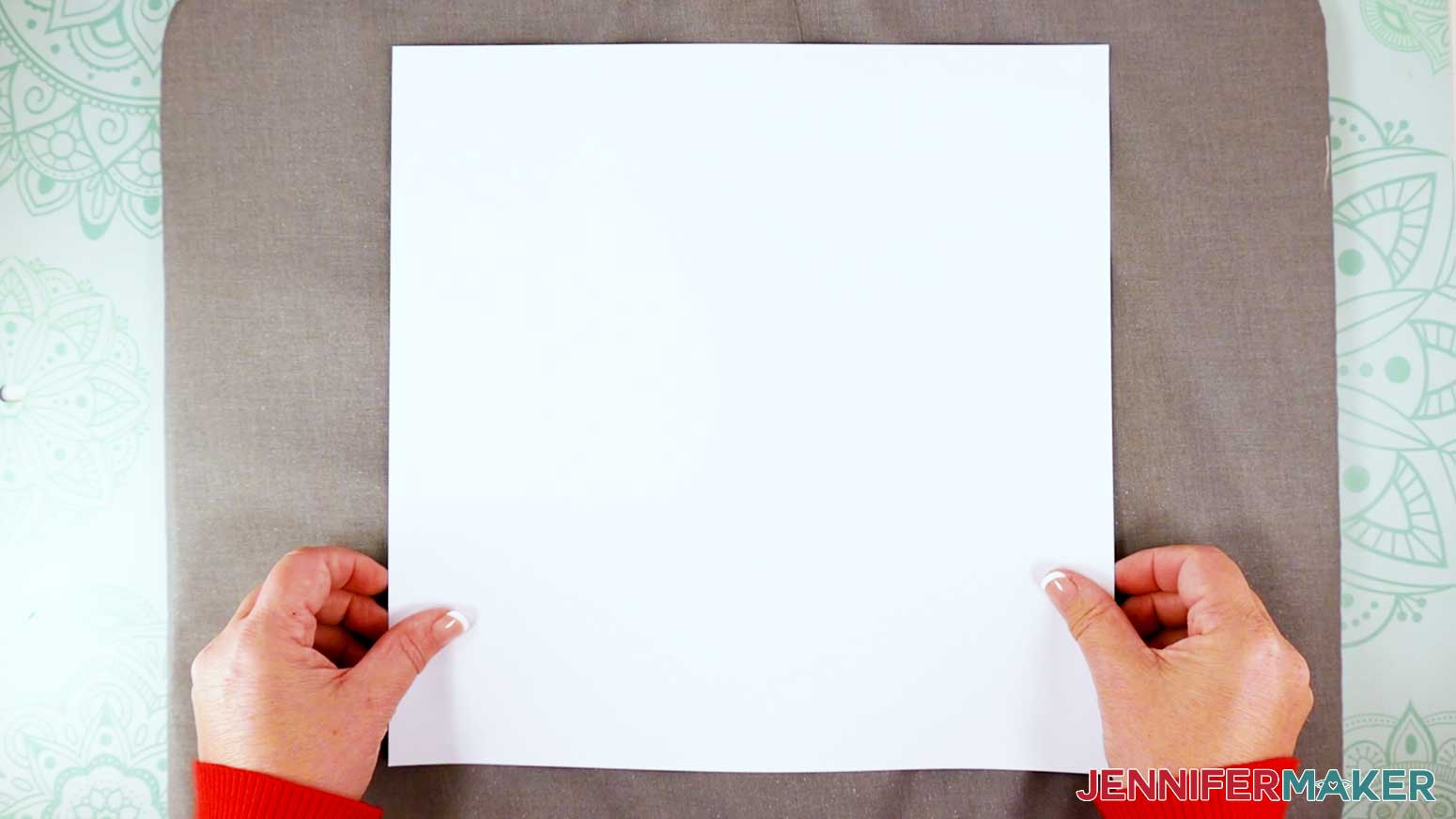 Place a piece of plain white cardstock on a pressing mat to protect the mat from the sublimation ink.