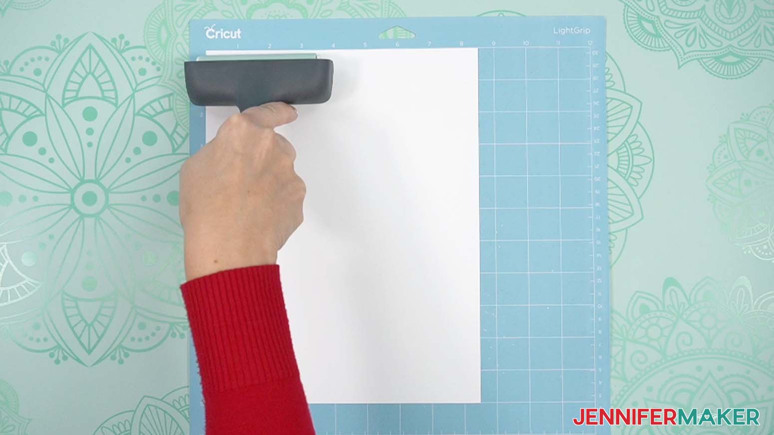 Place your copy paper on a blue LightGrip machine mat use a brayer to smooth it down