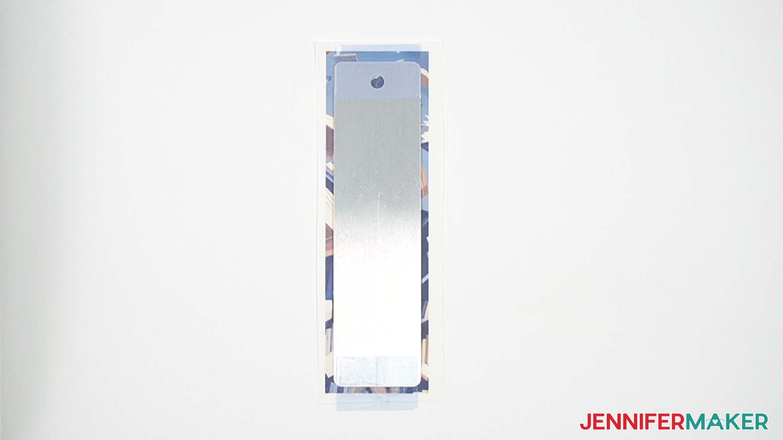 Bookmark taped with heat resistant tape to a sublimation design.