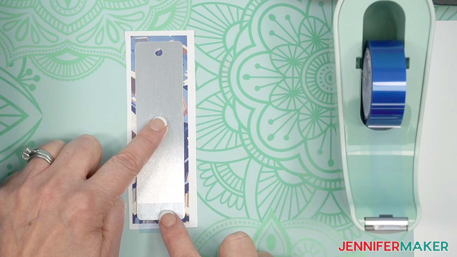 Press the tape first onto a short edge of the bookmark