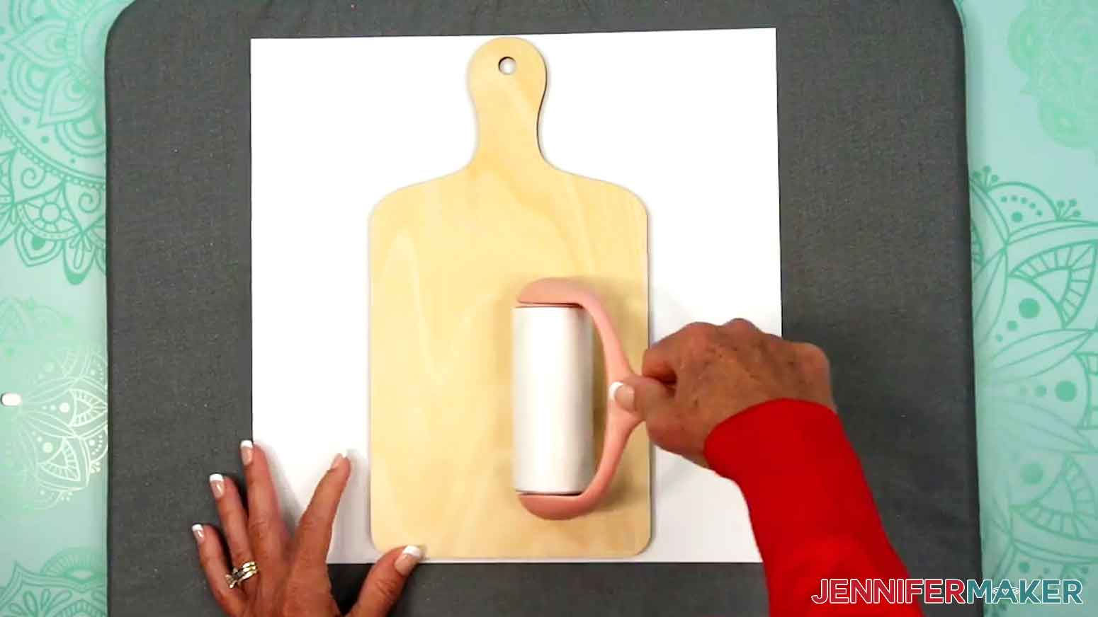 Use a lint roller to clean the charcuterie board before taping the charcuterie board sublimation design into place.