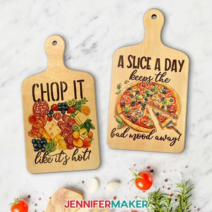 On the left: A sublimated charcuterie board with a fruit and cheese design and the words "Chop it like it's hot!" On the right: A sublimated charcuterie board with a pizza design and the words "A slice a day keeps the bad mood away!"