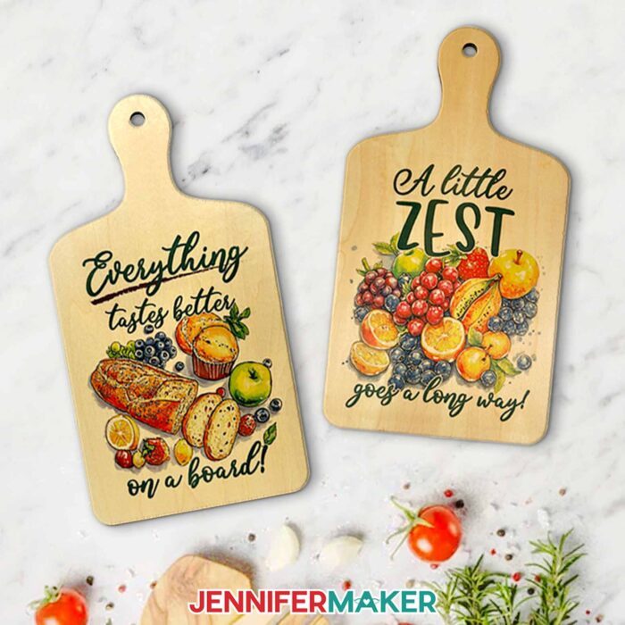 On the left: A sublimated charcuterie board with a fruit and bread design and the words "Everything tastes better on a board!" On the right: A sublimated charcuterie board with a fruits design and the words "A little zest goes a long way!"