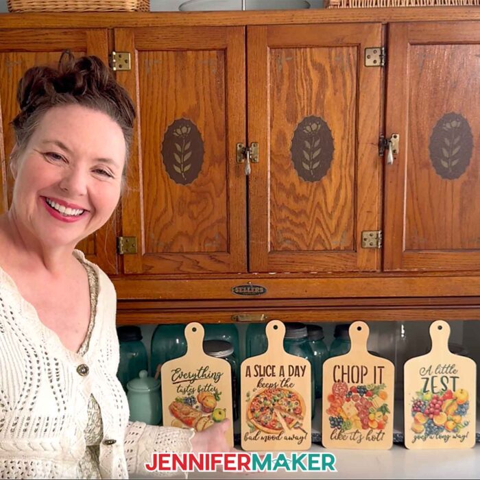 Jennifer Maker shows off some of the Best Sublimation Blanks on her kitchen counter: charcuterie boards decorated with cute, food related designs