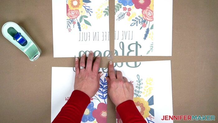 Jennifer is using heat-resistant tape to attach the four sublimation paper panels of her sublimation garden flag design. Learn how to sublimate your own garden flag with JenniferMaker's new tutorial!