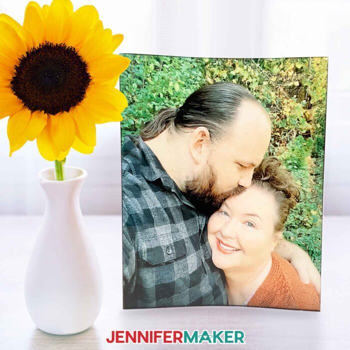 A curved panel with a happy photo of Jennifer Maker and her partner Greg made with sublimation on acrylic panels.