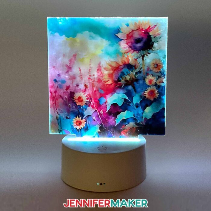 A square nightlight with watercolor sunflowers using sublimation on acrylic lit up in the dark.