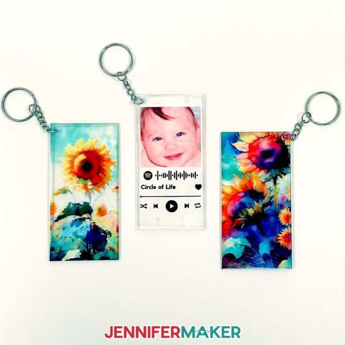 Three rectangular keychains with illustration and photo designs made with sublimation on acrylic.