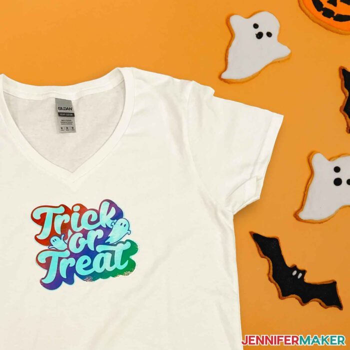 A white shirt with a sublimated holographic trick or treat design in a tutorial for how to sublimate on cotton and dark colors