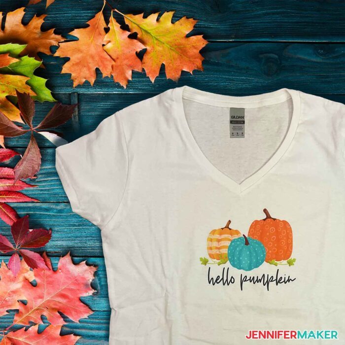 A white shirt with a sublimated pumpkin design in a tutorial for how to sublimate on cotton and dark colors