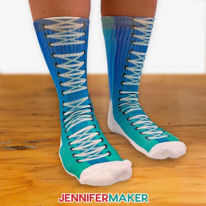 Person wearing sublimation socks with high top sneaker designs in a blue ombre pattern.
