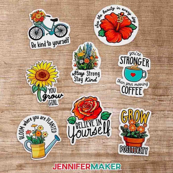 Learn how to sublimate a sticker sheet with JenniferMaker's tutorial! Die-cut sublimated stickers are on a wooden table. The stickers are brightly colored, and flower and garden themed, with inspiring messages like "Believe In Yourself," Stay Strong, Stay Kind," and "Grow Positivity."