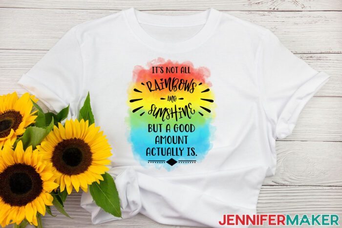 White sublimation t-shirt with a rainbow design that reads "it's not all rainbows and unicorns but a good amount actually is" with sunflowers
