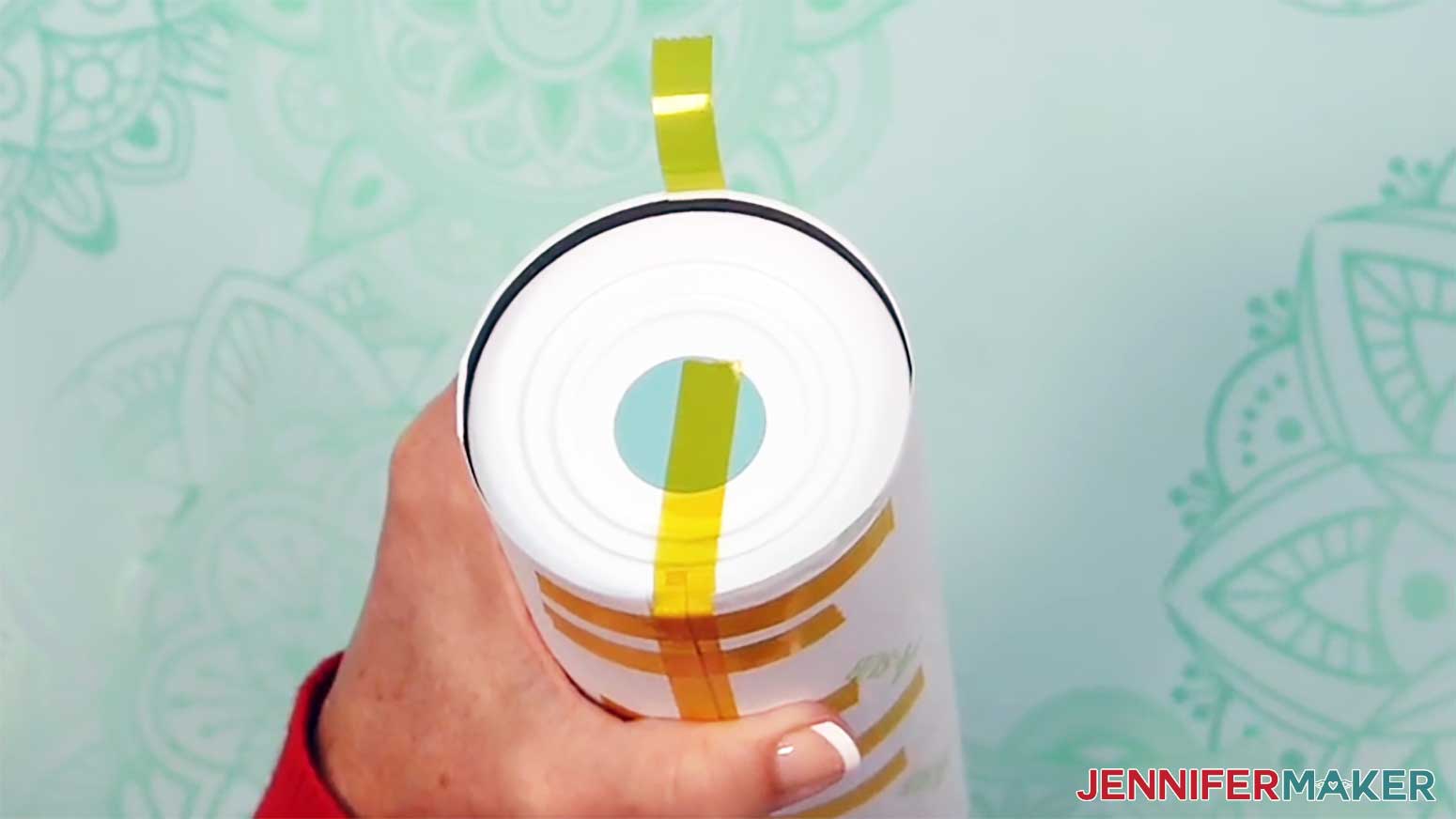Place a second piece of tape across from the first on the bottom of the glow in the dark tumbler.