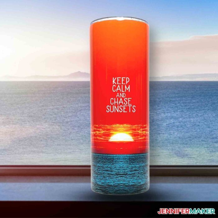 A sublimation tumbler featuring a sunset photo with white text reading keep calm and chase sunsets.