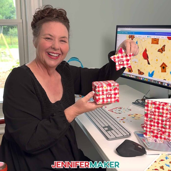 Jennifer Maker shows of a wrapped gift with paper printed with a Seamless Pattern In Canva she made