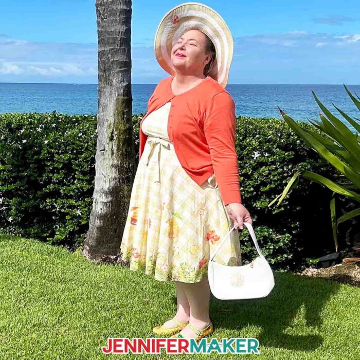 Jennifer Maker smiling in the sun wearing her custom sublimation design Dole Whip dress on vacation in Hawaii.