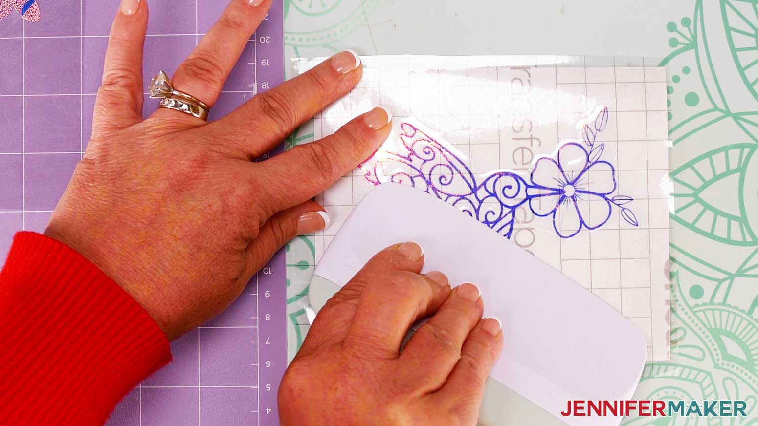 Use a scraper tool to burnish the holographic vinyl to the window cling.