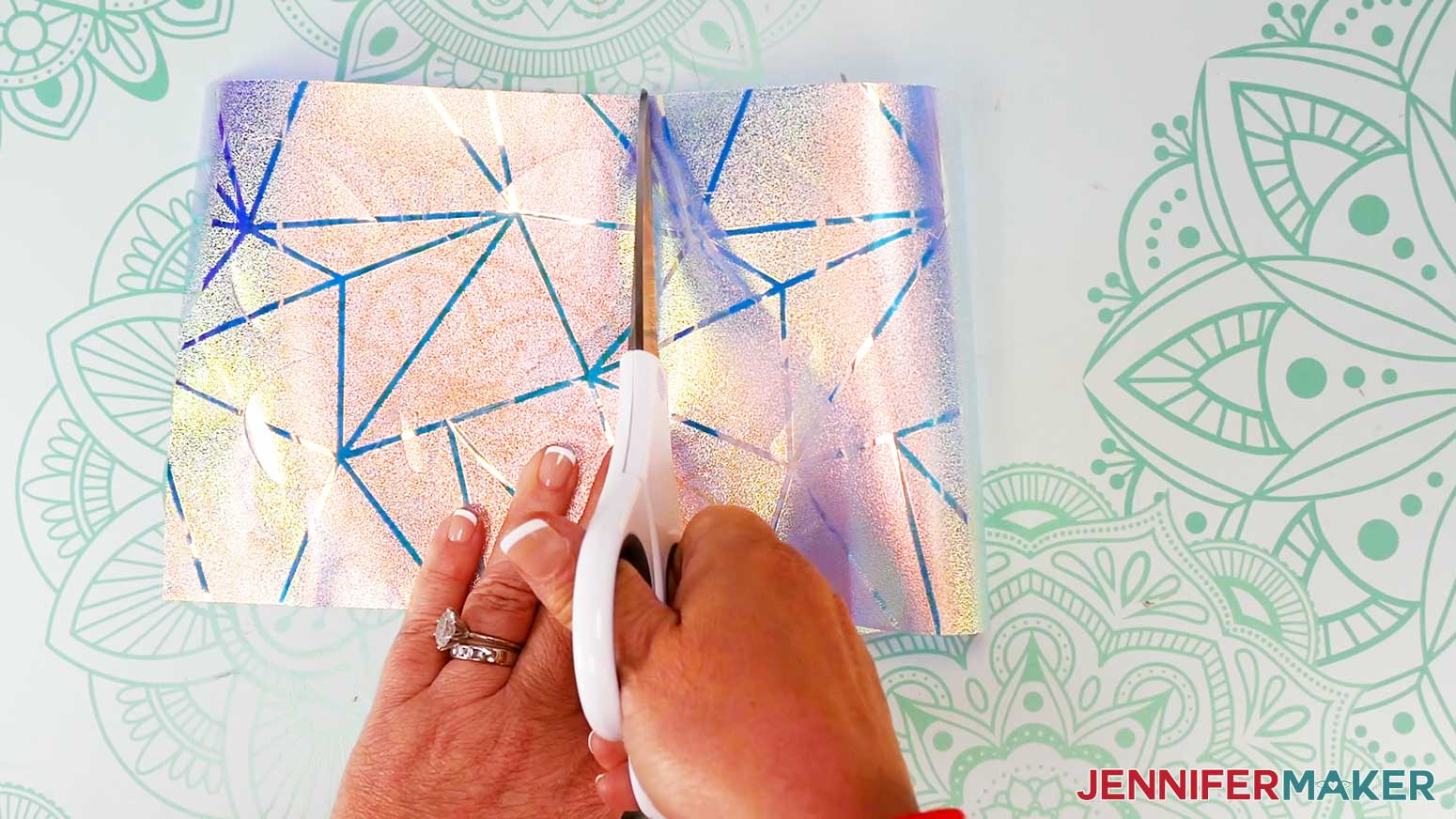Use scissors to cut apart the two designs on the window cling material.