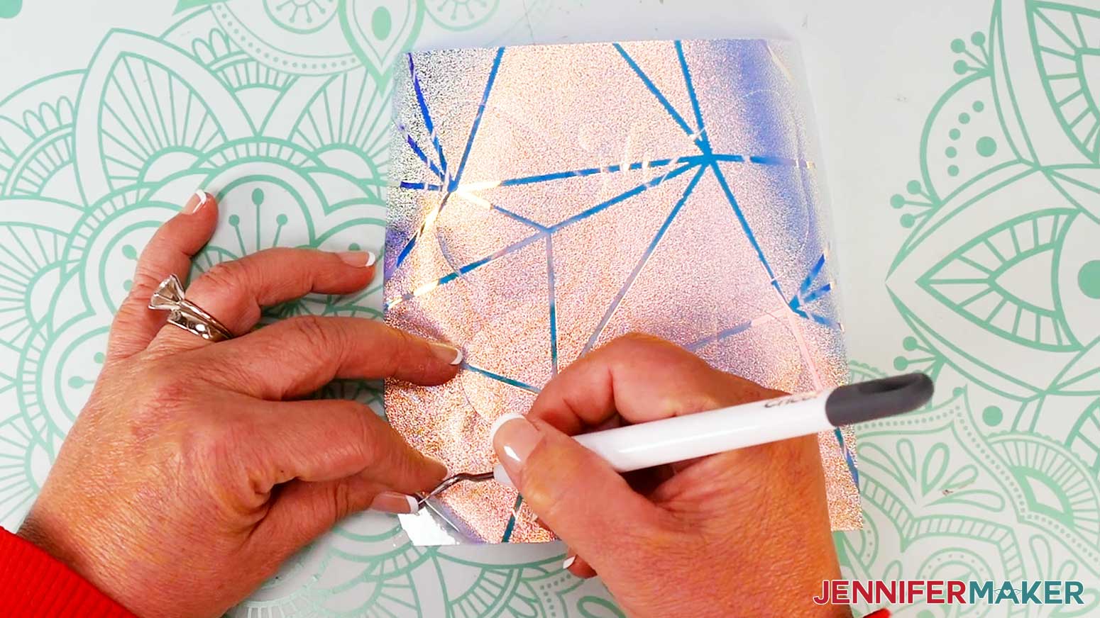 Use a weeding tool to remove the excess window cling from the carrier sheet.