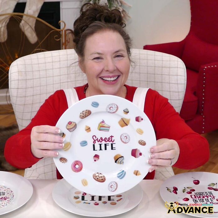 Jennifer Maker smiles and shows off a custom plate she decorated with waterslide decals as part of her Waterslide Decals For Beginners tutorial in her ADVANCE with JenniferMaker program