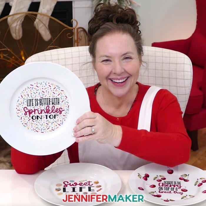 Jennifer Maker smiles and shows off a plate she decorated with waterslide decals of sprinkles as part of her Waterslide Decals For Beginners tutorial