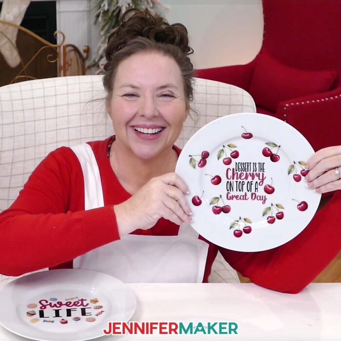 Jennifer Maker smiles and shows off a plate she decorated with waterslide decals of cherries as part of her Waterslide Decals For Beginners tutorial