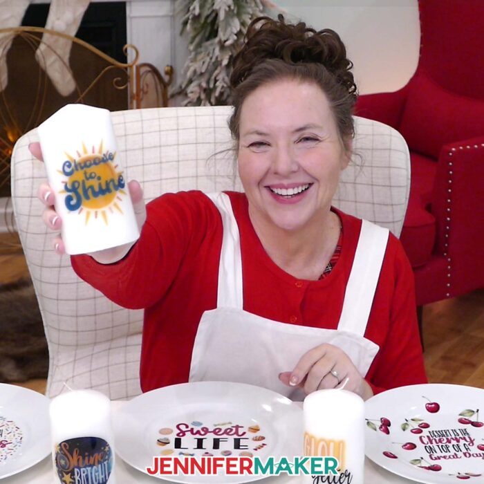 Jennifer Maker smiles and shows off a candle she decorated with a waterslide decal as part of her Waterslide Decals For Beginners tutorial