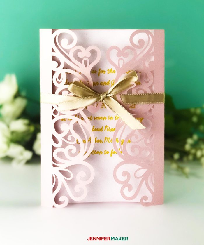 Pink laser cut filigree invitation with gold ribbon for the DIY Wedding Invitation Template Tutorial