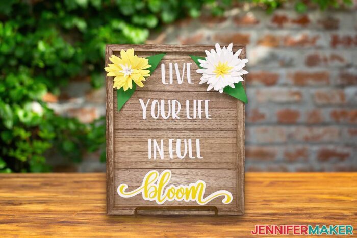 Wooden frame from Target Dollar Spot DIYs with Live your life in full bloom yellow and white decal and cardstock flowers.