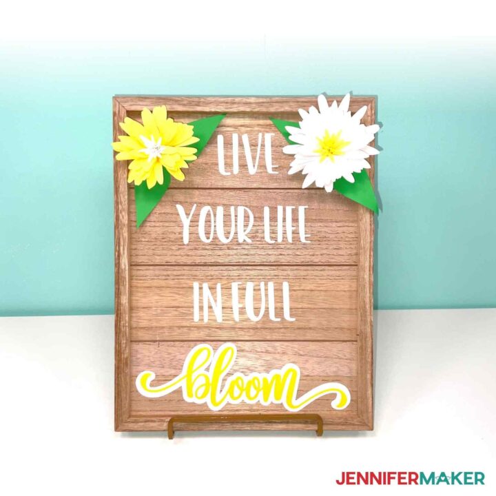 Wooden frame from Target Dollar Spot DIYs with Live your life in full bloom yellow and white decal and cardstock flowers.