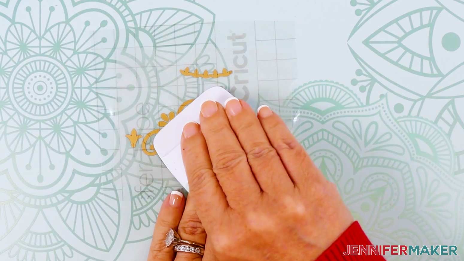 Burnish the transfer tape over the decal using the Cricut scraper tool.