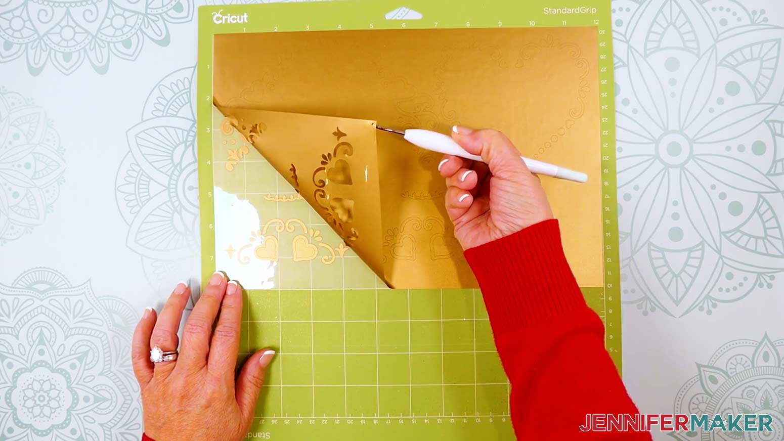 Use a weeding tool to remove the larger pieces of background vinyl.