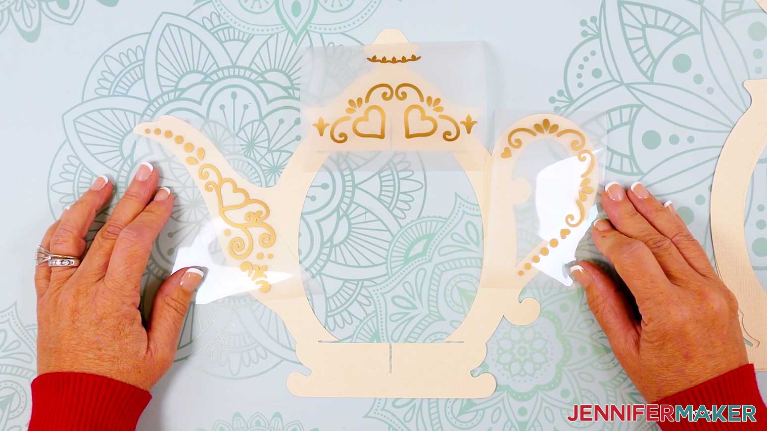 Place the first set of lid, handle, and spout decals, vinyl side up, on the teapot lantern frame.