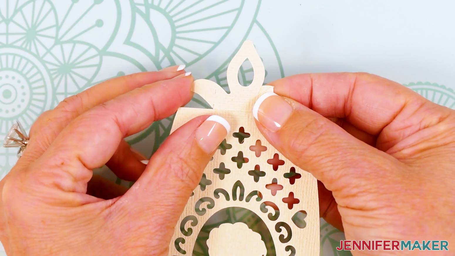 Fold back the top tab&rsquo;s two wings along the vertical dashed cut lines.